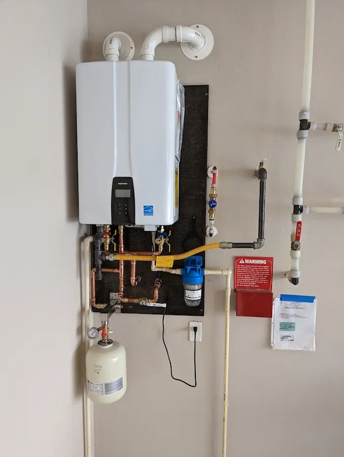 Professional plumber installing copper piping in a Mountain Home AFB home